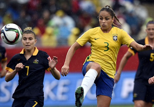 Brazil's defender Monica (R) kicks the ball in front Australia's defender Steph Catley.