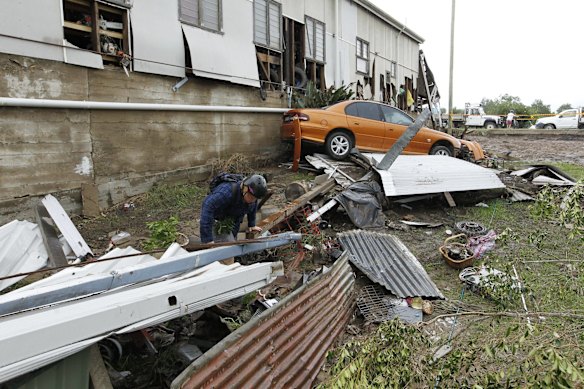 A young boy searching through wreckage, where his best friend's house was washed away, in Dungog. 