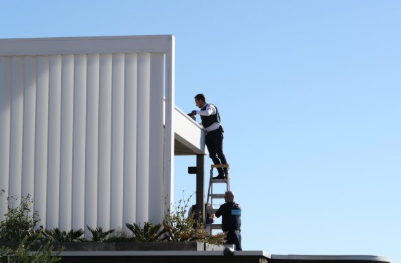 Police search the gutters of John Ibrahim's Dover Heights home in 2017.