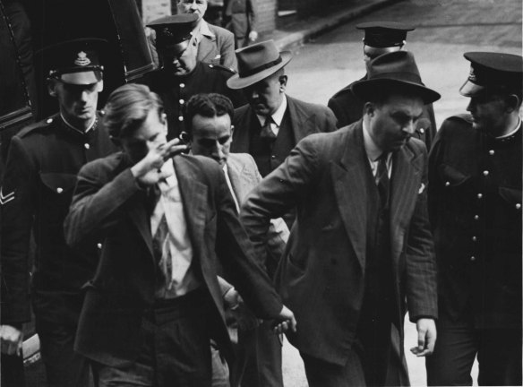 “Police and Detectives flank Sydney Grant and Keith Hope as they enter the city coroner’s court today for the inquest on Det. - Const. Victor Ahearn, shot at Matraville on August 11. ” September 10, 1946