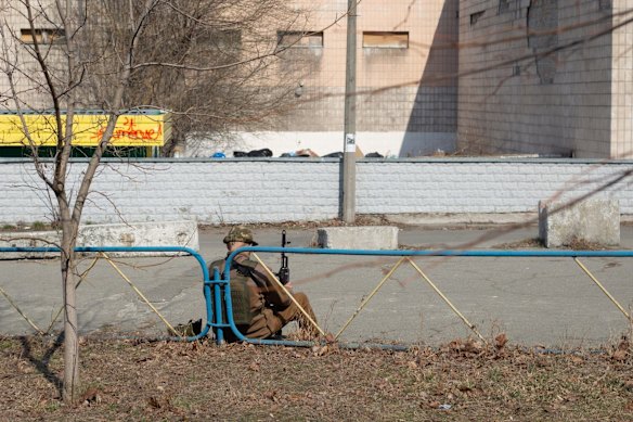 A Ukrainian serviceman waits outside a hospital in Kyiv, Ukraine.