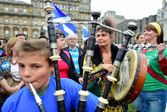A young piper plays in George Square.