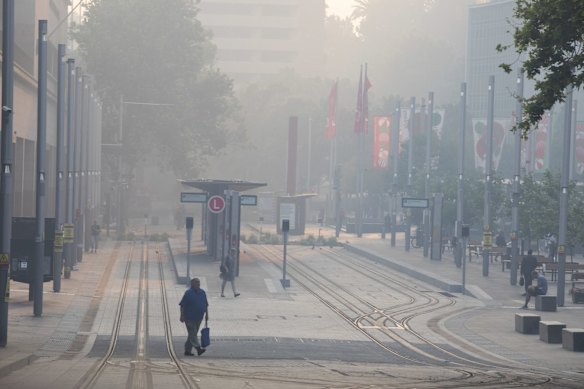 Commuters braving the smoke at a light rail station in Sydney's east.
