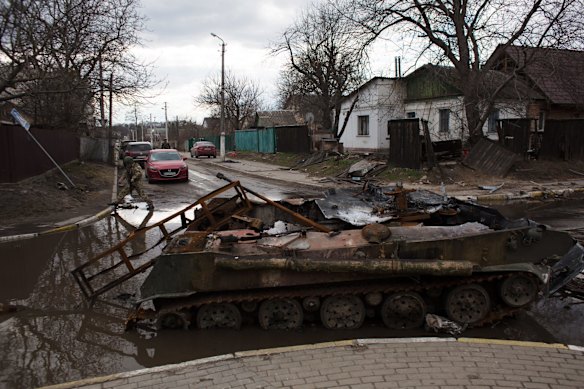 Ukrainian servicemen patrol the streets of Bucha.