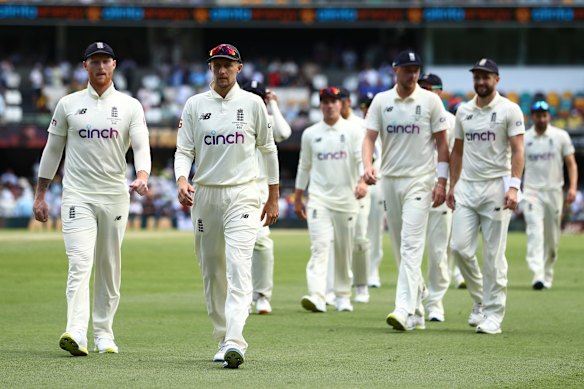 Joe Root of England walks off the field with team mates after losing during day four of the First Test Match in the Ashes series between Australia and England at The Gabba.