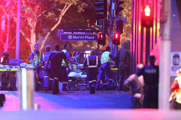 Ambulance officers move into the Lindt Chocolat Cafe as the siege comes to a dramatic end.