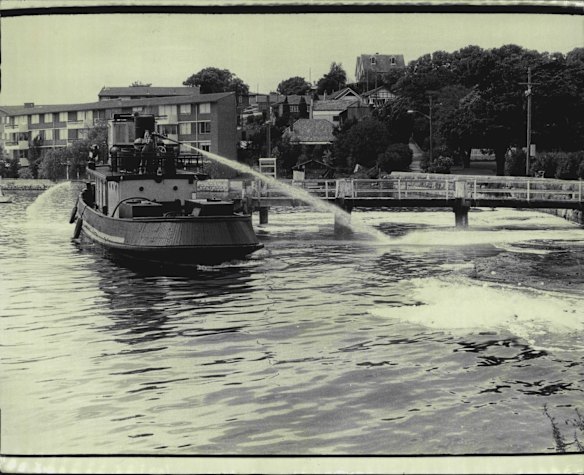 A fire-float disperses oil spillage in Berry's Bay. December 15, 1973.