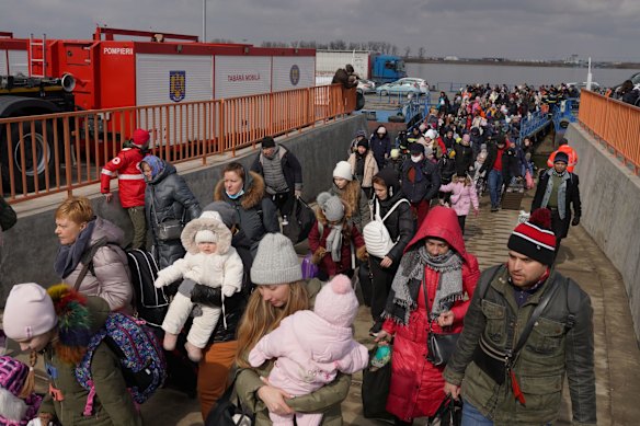 Ukranian refugees get off a ferry at the border crossing into Romania at Isaccea. According to the United Nations Children's Fund more than 138,454 Ukrainian citizens have entered Romania and 87,193 have left the country to move on to other destinations since Russia began a large-scale attack.