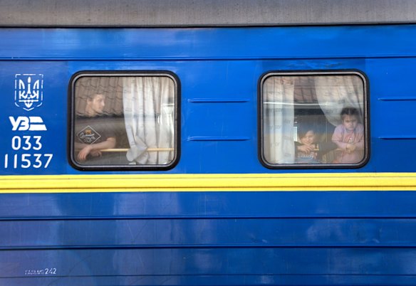 People arrive on the train in Lviv after fleeing Russian attacks.