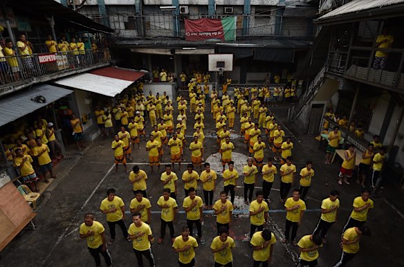 Inmates during a flag raising ceremony inside Quezon City Jail, Manila, Philippines. 
