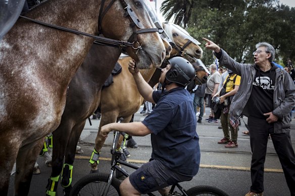 Mounted police clash with protesters outside the NGV.