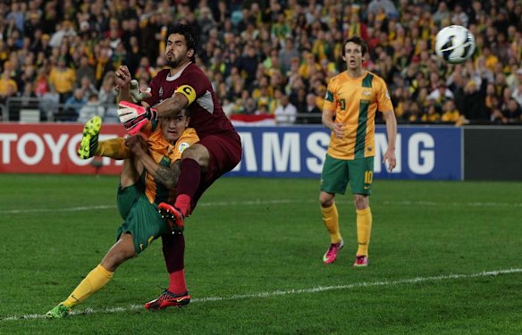 Tim Cahill of the Socceroos shoots at goal under pressure from Noor Sabri Abbas of Iraq.