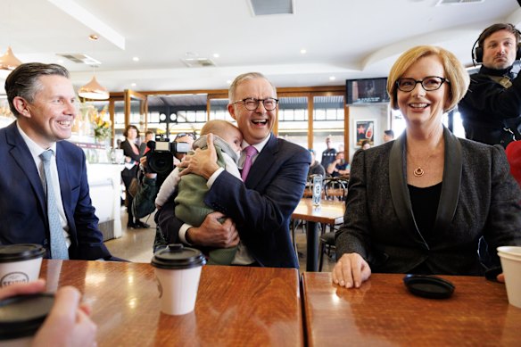 Opposition Leader Anthony Albanese holds Charlie Butler, as he meets with former Prime Minister Julia Gillard  during a visit to Sfizio Cucina cafe in the seat of Sturt, in Adelaide, SA, on Friday 20 May 2022. ausvotes22 fedpol Photo: Alex Ellinghausen