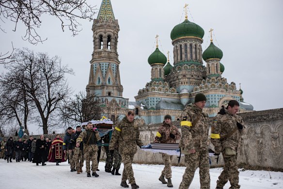 Ukrainian soldiers carry the body of Denys Hrynchuk, who served in the Ukrainian Army, from Hrynchuk family's house to the church in Bila Krynytsia in the Chernivtsi region, Ukraine.