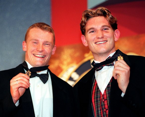 The 1996 Brownlow medallists Michael Voss (Brisbane) left, and James Hird (Essendon) hold their medals aloft after both polling 21 votes