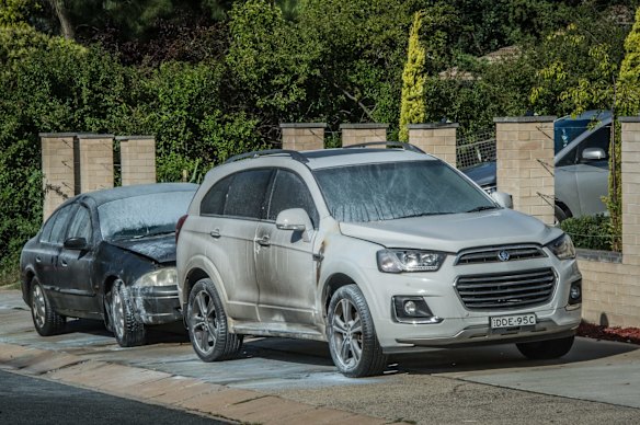 Police officers and forensic staff attend the scene of an overnight shooting and arson attack in Harrington circuit, Kambah. Numerous bullets have hit the home and three vehicles have been set alight. 
