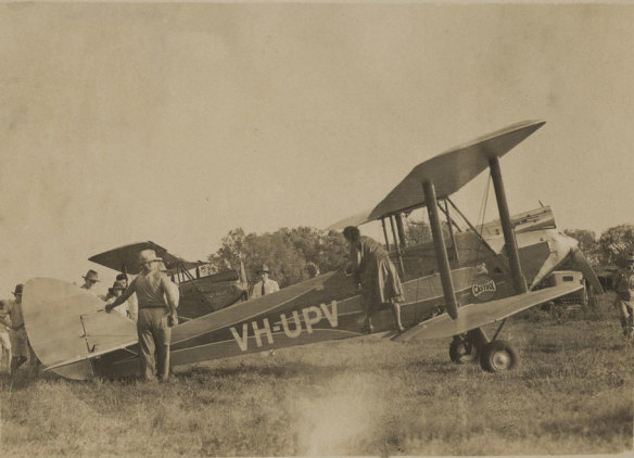 “Mrs Lores Bonney overhauls her machine, a DH 60G Moth, My Little Ship, VH-UPV, at Darwin.”