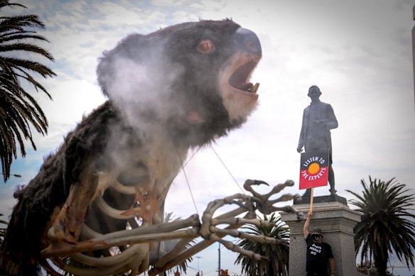 A closer view of 'Blinky' in front of the Captain Cook statue near St Kilda pier, at the Extinction Rebellion protest against inaction on climate change.