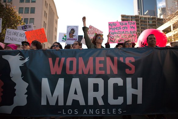 Demonstrators hold a signs and a banner while marching during the Women's March of Los Angeles in Los Angeles, California, U.S.