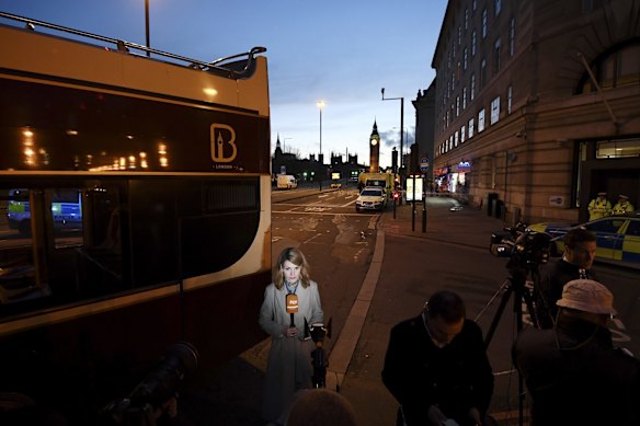 A member of the press speaks to camera following a terrorist attack outside the Houses of Parliament.