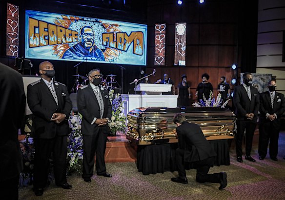 Minneapolis Mayor Jacob Frey kneels by the casket of George Floyd before a memorial service at North Central University.