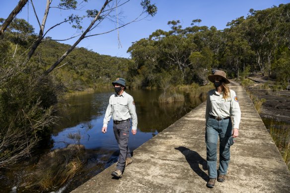 Brendon Neilly, Area Manager of the Royal National Park and Jodie McGill, a ranger for the Heathcote National Park, during a visit this week to the Woronora River within the parks estate.