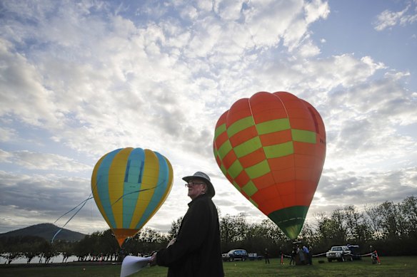 Hot air balloons inflating on the lawns in front of Old Parliament House for the Canberra Balloon Spectacular festival.