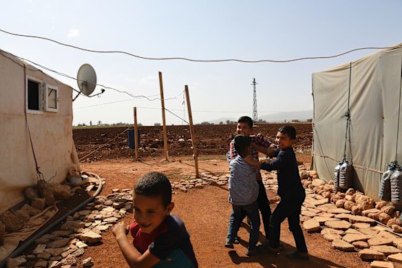 A group of Syrian children play around the temporary shelters in Saideh camp in the Bekaa Valley in Lebanon.