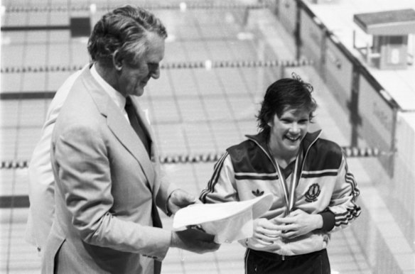 Australia's Tracy Wickham receives her gold medal following victory in the Women's 800m Freestyle at the 1982 Commonwealth Games in Brisbane on 4 March 1982. She is pictured with Australian Prime Minister Malcolm Fraser.