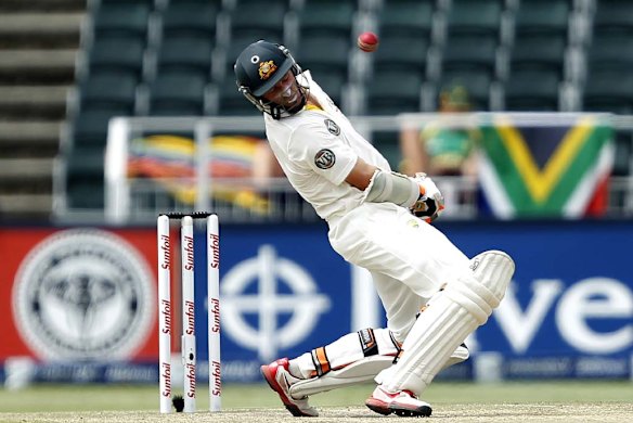 Mike Hussey ducks under a bouncer from Dale Steyn.