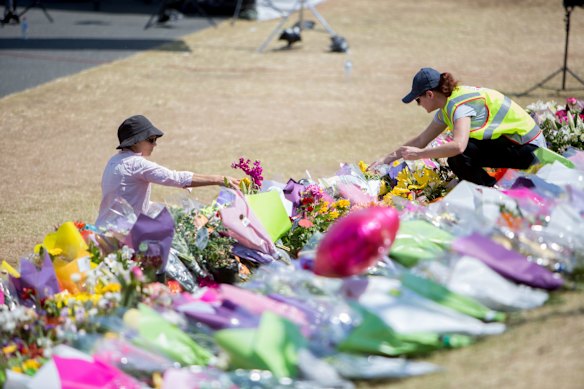 People lay tribute at Dreamworld whilst a private memorial service was held inside.