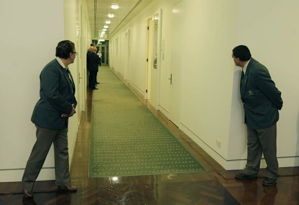 Attendants look twards the caucus room as the leadership ballot continues at Parliament House.
