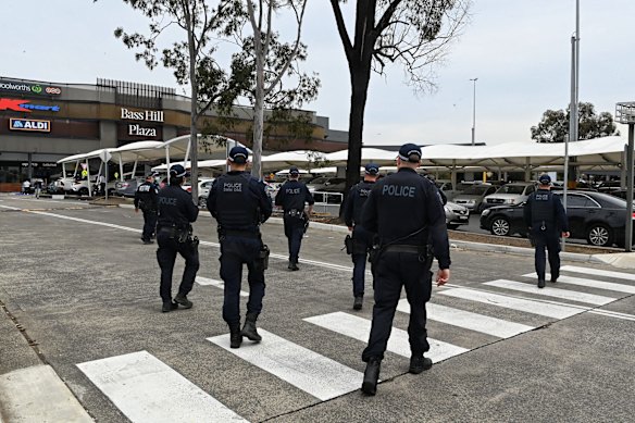 Police arrive at Bass Hill Shopping centre in preparation for a possible anti-lockdown protest.