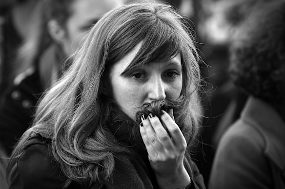 Faces of Paris. Parisians silently paid respect to the 129 people killed in the terror attack in Paris across many memorial sites including Le Carillon bar.
