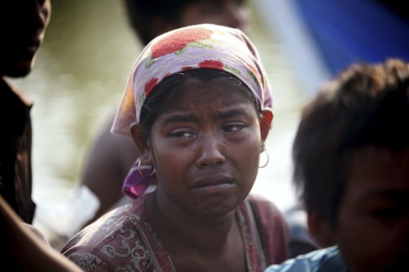 A rescued migrant weeps upon arrival Simpang Tiga, Aceh province, Indonesia, Wednesday, May 20, 2015. Hundreds of migrants stranded at sea for months were rescued and taken to Indonesia, officials said Wednesday, the latest in a stream of Rohingya and Bangladeshi migrants to reach shore in a growing crisis confronting Southeast Asia. 