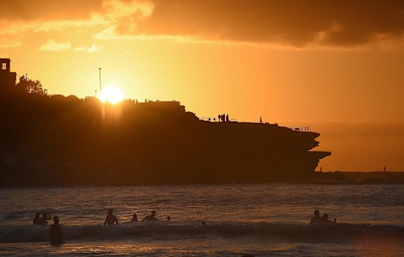 Sun rises over Bondi Beach, hundreds of people gathered on Bondi Beach to bring in the new year. 