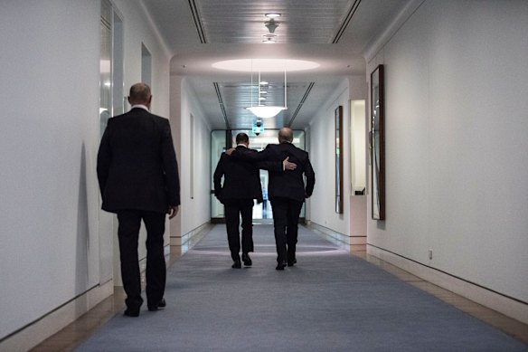Incoming Prime Minister Scott Morrison and newly elected deputy leader of the Liberal Party Josh Frydenberg  walk down the ministerial office hall after speaking to media at Parliament House in Canberra.