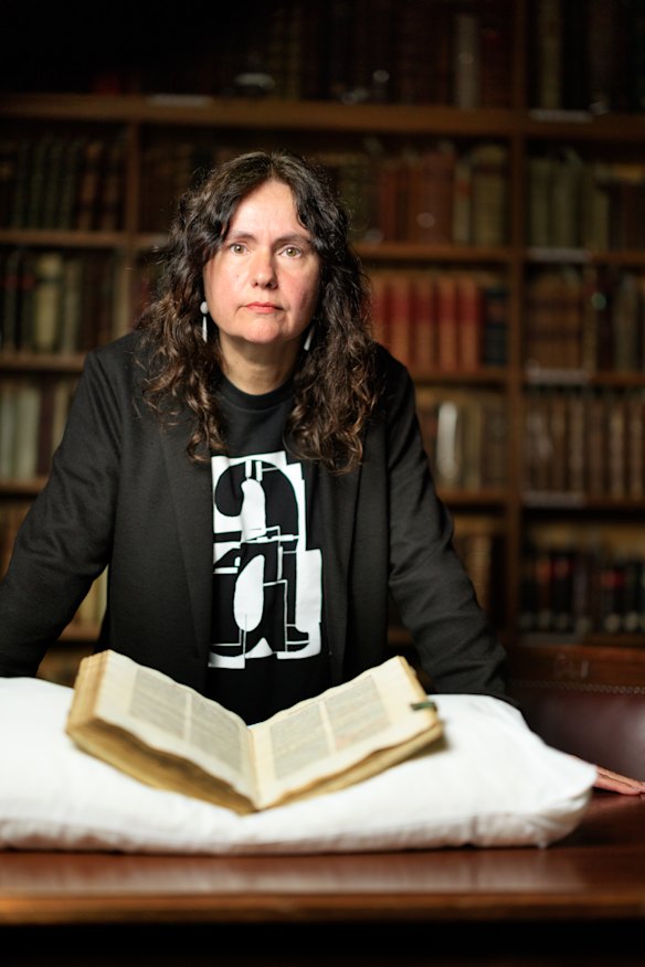 Susan Millard pictured with the Malleus Maleficarum.
