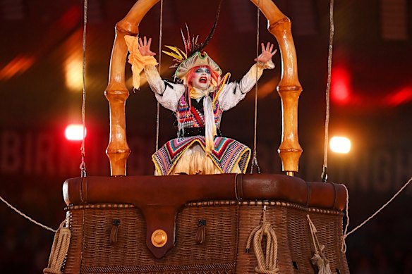 A performer performs inside a hot air balloon.