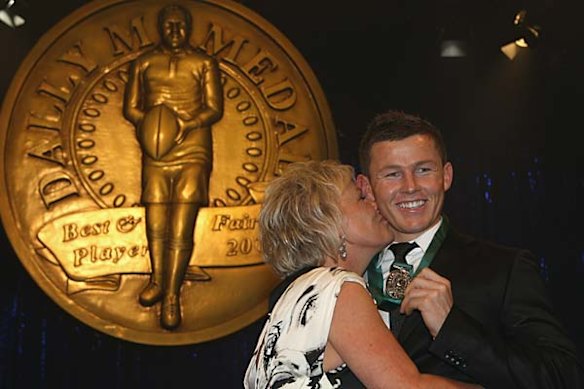 Todd Carney receives a kiss from his mother Leanne.