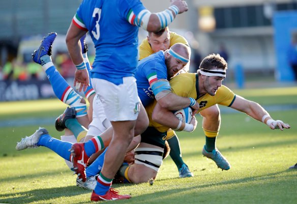 Izack Rodda, right, is tackled by Italy's Leonardo Ghiraldini.