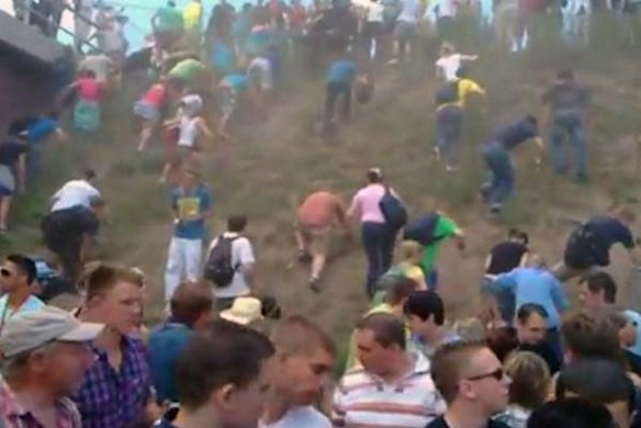 In this image taken from television, people try to escape after a panic on this year's techno-music festival Love parade 2010 in Duisburg, Germany.