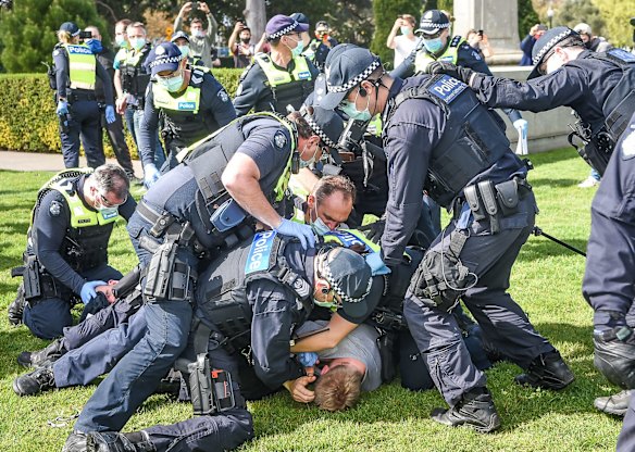 Police making an arrest after a scuffle with protestors.
