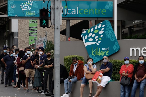 People queue at the Kildare Road Medical Centre in Blacktown for a COVID PCR test.