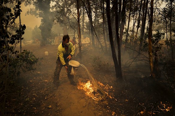 Oakdale residents defend their property as the bushfire approaches, in Oakdale, NSW.