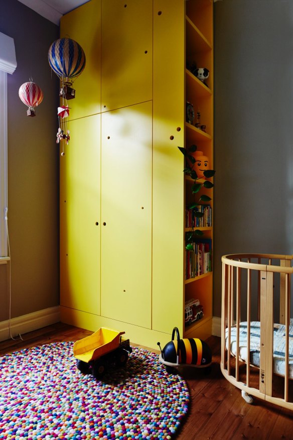 For the children’s room, Anna designed the wardrobe and bookshelf, which is painted in vibrant “Dandelion Yellow” by Dulux. Evie’s cot is by Stokke.