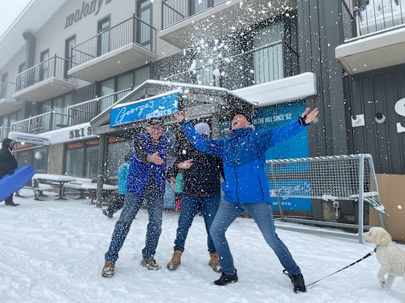 Rob Aivatoglou (in blue with cap) owns George's Ski Hire, an institution in the Mt Buller village and founded by his dad George whose name is over the door. He is thrilled to see the snow and is excited to open again.