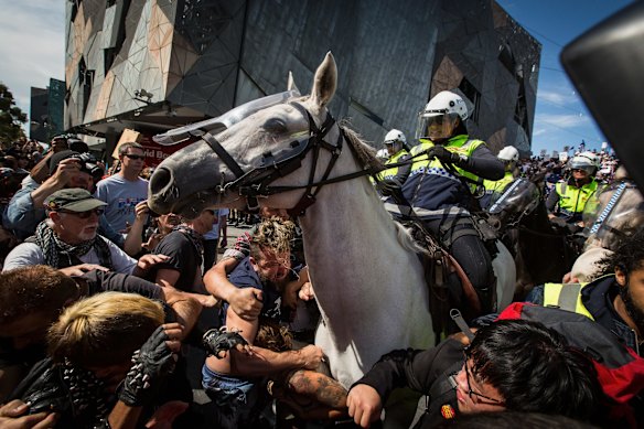 Protesters clash with Reclaim Australia protesters at Federation Square under a huge police presence. 