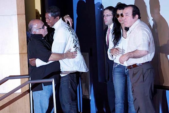 Jermaine Jackson hugs a man after speaking about his brother Michael Jackson's death at a a press conference.
