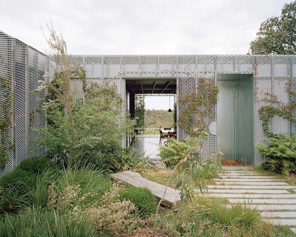 A climber-covered trellis screens ‘Hedge House’ itself from its garden.